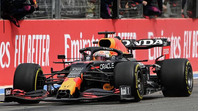 Red Bull's team members celebrate as winner Red Bull's Dutch driver Max Verstappen crosses the finish line during the French Formula One Grand Prix at the Circuit Paul-Ricard in Le Castellet, southern France, on June 20, 2021. (Photo by CHRISTOPHE SIMON / AFP)