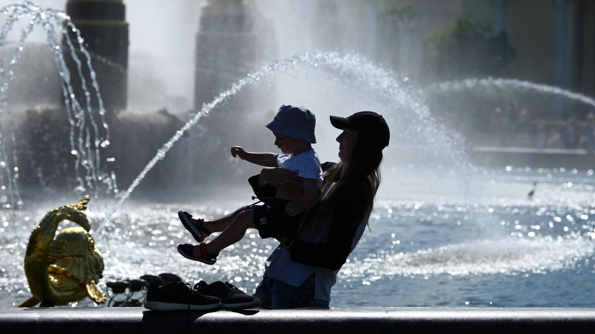 Женщина с ребенком в жаркую погоду у фонтана Дружба народов на ВДНХ - РИА Новости, 1920, 25.06.2021