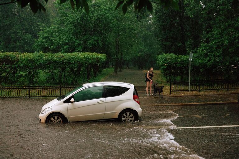 Автомобиль на одной из улиц в Москве во время дождя Автомобиль на одной из улиц в Москве во время дождя