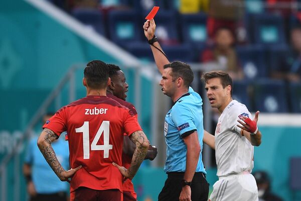 Главный арбитр Майкл Оливер показывает красную карточку полузащитнику сборной Швейцарии Ремо Фройлеру