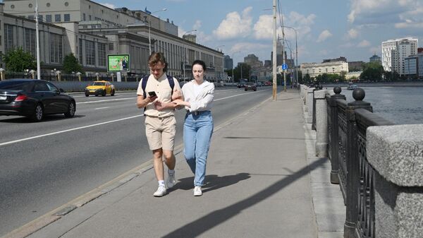 Молодые люди гуляют на Бережковской набережной в Москве