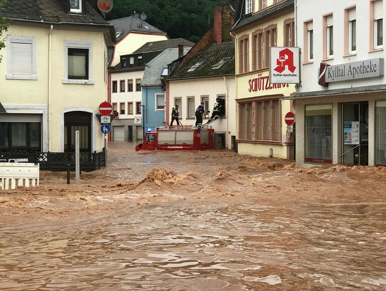 Пожарные забираются в дом в затопленном районе Эранг в Трире, западная Германия