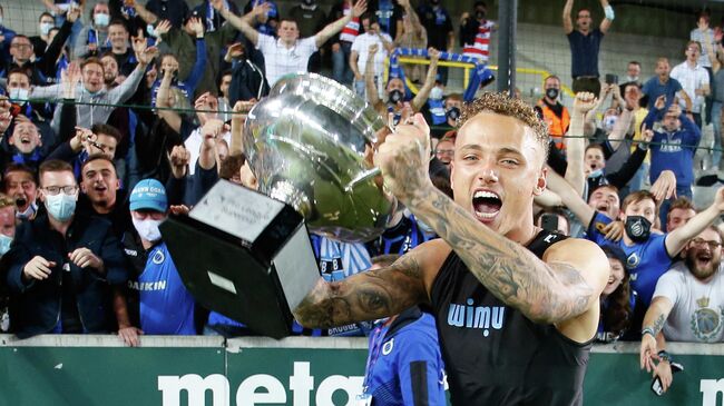 Club Brugge's Dutch midfielder Noa Lang celebrates with the trophy after winning the Belgian Super Cup match between Club Brugge KV and KRC Genk, in Bruges on 17 July 2021. (Photo by BRUNO FAHY / Belga / AFP) / Belgium OUT