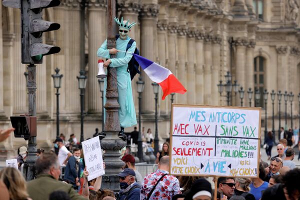 Демонстрант в костюме статуи Свободы принимает участие в акции протеста против объявленных президентом Франции Эммануэлем Макроном новых мер по борьбе с COVID-19 в Париже