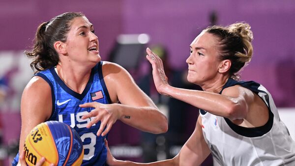 USA's Stefanie Dolson (L) fights for the ball with Russia's Anastasiia Logunova during the women's first round 3x3 basketball match between Russia and US at the Aomi Urban Sports Park in Tokyo, on July 25, 2021 during the Tokyo 2020 Olympic Games. (Photo by Andrej ISAKOVIC / AFP)