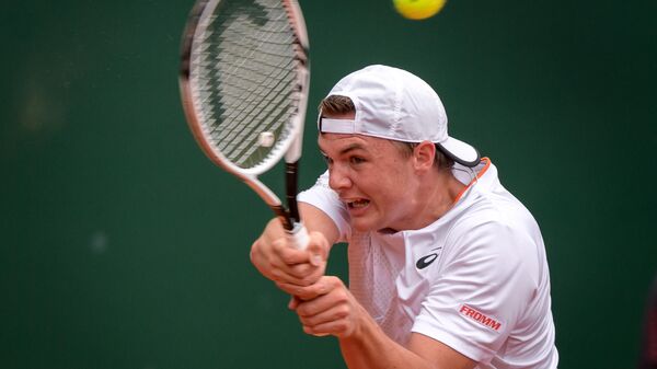 Switzerland's Dominic Stricker returns a ball during his ATP 250 Geneva Open tennis match against Croatia's Marin Cilic in Geneva on May 18, 2021. (Photo by Fabrice COFFRINI / AFP)
