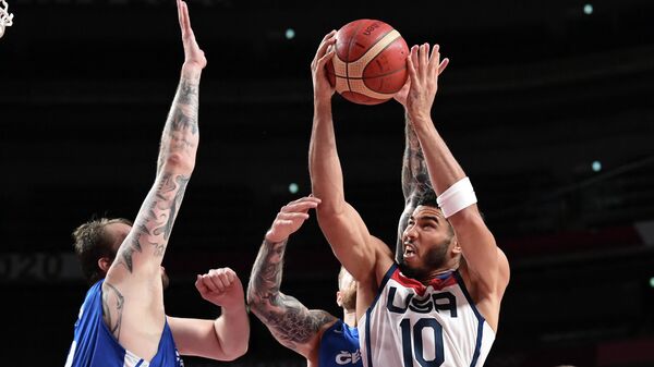 USA's Jayson Tatum (R) goes to the basket past Czech Republic's Ondrej Balvin (L) in the men's preliminary round group A basketball match between USA and Czech Republic during the Tokyo 2020 Olympic Games at the Saitama Super Arena in Saitama on July 31, 2021. (Photo by Aris MESSINIS / AFP)