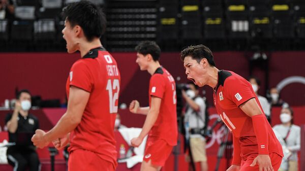 Japan's Yuji Nishida (R) celebrates their victory in the men's preliminary round pool A volleyball match between Japan and Iran during the Tokyo 2020 Olympic Games at Ariake Arena in Tokyo on August 1, 2021. (Photo by Yuri Cortez / AFP)