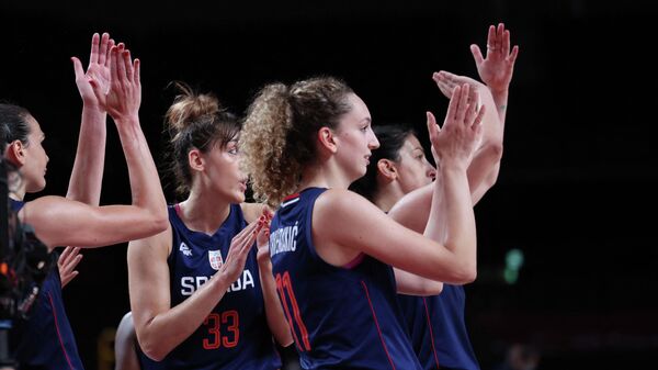 Serbian players celebrate their win in the women's preliminary round group A basketball match between South Korea and Serbia during the Tokyo 2020 Olympic Games at the Saitama Super Arena in Saitama on August 1, 2021. (Photo by Thomas COEX / AFP)