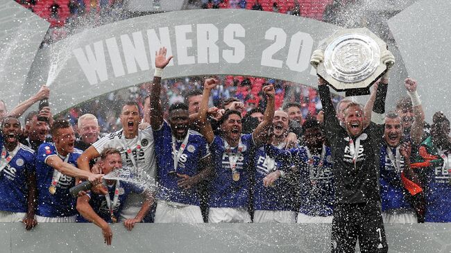 Leicester City's Danish goalkeeper Kasper Schmeichel holds aloft the Community Shield trophy after Leicester City won the English FA Community Shield football match between Manchester City and Leicester City at Wembley Stadium in north London on August 7, 2021. (Photo by Adrian DENNIS / AFP) / NOT FOR MARKETING OR ADVERTISING USE / RESTRICTED TO EDITORIAL USE