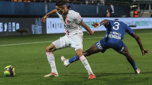 Paris Saint-Germain's Moroccan defender Achraf Hakimi (L) fights for the ball against Troyes Malian defender Youssouf Kone  during the French L1 football match between Paris Saint-Germain (PSG) and ES Troyes at the Stade de l'Aube in Troyes on August 7, 2021. (Photo by Franзois NASCIMBENI / AFP)