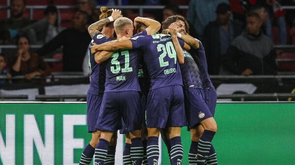 PSV players celebrate the fourth goal of PSV Eindhoven's Mario Gotze during the football Johan Cruyff Shield (Dutch Super Cup) match between Ajax and PSV Eindhoven in the Johan Cruijff Arena in Amsterdam, on August 7, 2021. (Photo by Jeroen Putmans / ANP / AFP) / Netherlands OUT