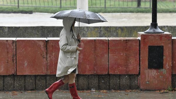 Женщина под зонтом на улице в Керчи