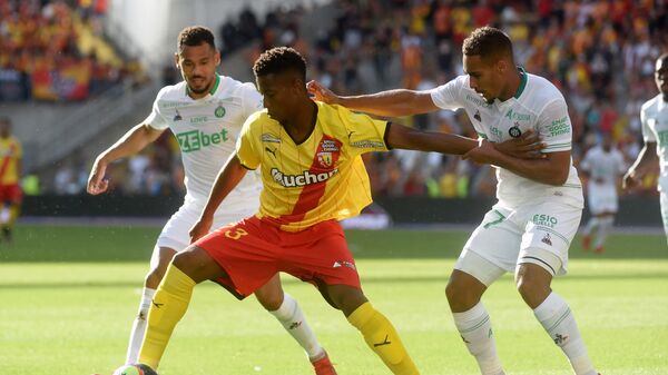 Lens's Bokote Banza and Saint Etienne's Yvann Macon fight for the ball during the French L1 football match between Lens and Saint-Etienne at the Bollaert Stadium in Lens, on August 15, 2021. (Photo by FRANCOIS LO PRESTI / AFP)