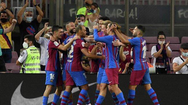 Barcelona's Danish forward Martin Braithwaite (3L) celebrates with teammates after scoring during the Spanish League football match between Barcelona and Real Sociedad at the Camp Nou stadium in Barcelona on August 15, 2021. (Photo by Josep LAGO / AFP)