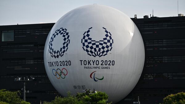 The Tokyo 2020 Olympic and Paralympic logos are displayed on the Hinomaru driving school building in Tokyo on June 29, 2020. (Photo by CHARLY TRIBALLEAU / AFP)