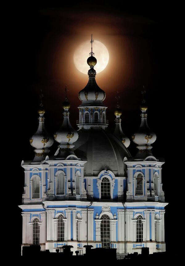 Вид на Смольный собор на фоне полной луны в Санкт-Петербурге