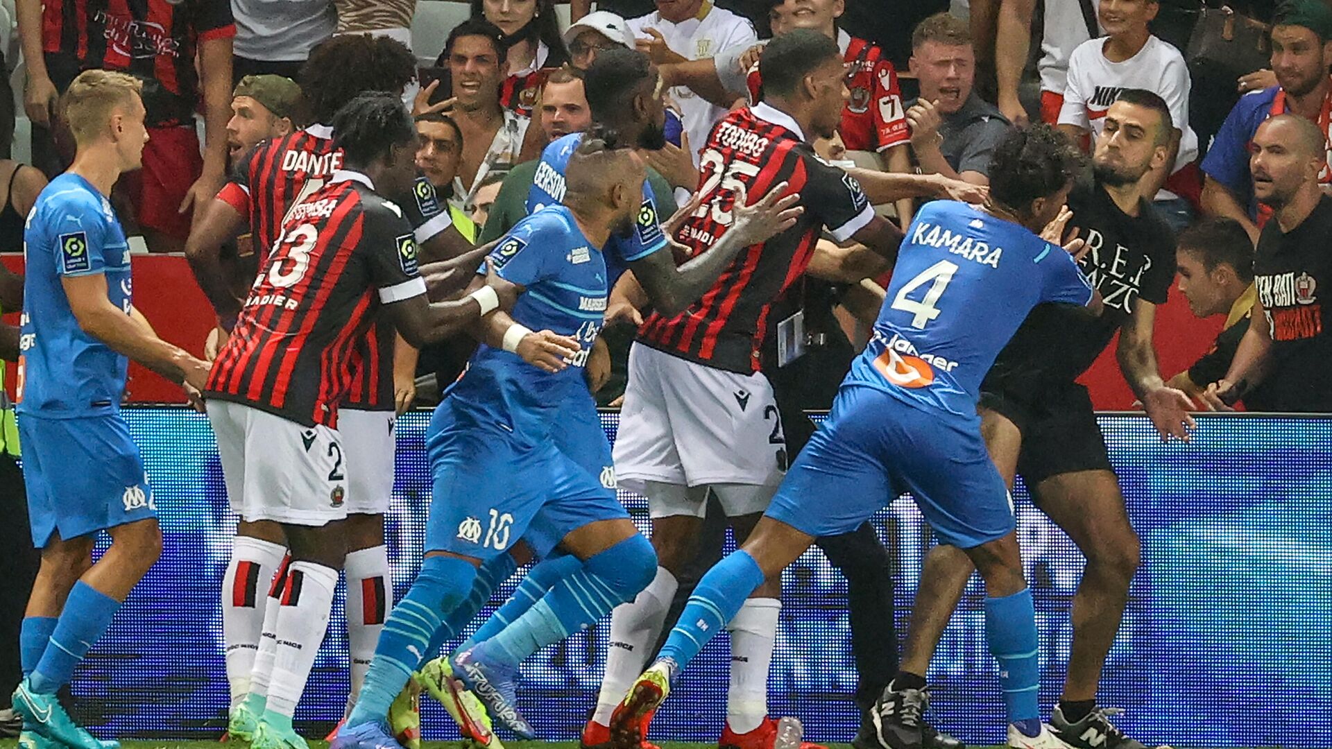 Marseille's French midfielder Dimitri Payet (C) reacts as players stop a fan (R) invading the pitch during the French L1 football match between OGC Nice and Olympique de Marseille (OM) at the Allianz Riviera stadium in Nice, southern France on August 22, 2021. - The French Ligue 1 game between Nice and Marseille was halted on August 22, 2021, when fans of the home side invaded the pitch and angrily confronted opposing player Dimitri Payet. An AFP journalist at the game said trouble flared in the 75th minute when Marseille star Payet, who had been targeted by plastic bottles every time he took a corner, lobbed one back into the stands. (Photo by Valery HACHE / AFP) - РИА Новости, 1920, 23.08.2021