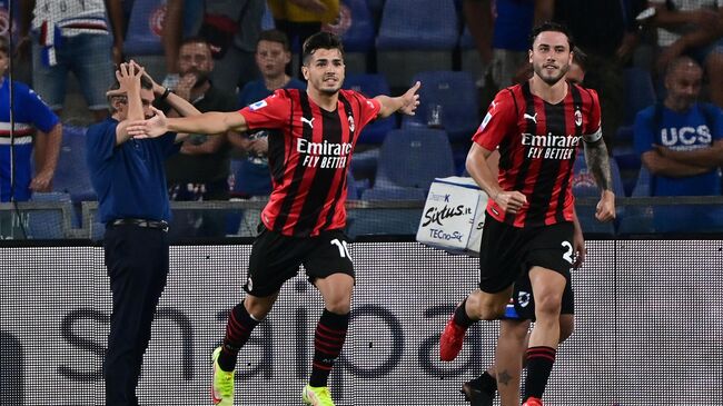 AC Milan's Spanish midfielder Brahim Diaz (L) celebrates after scoring  during the Italian Serie A football match between Sampdoria and AC Milan at the Luigi Ferraris stadium in Genova on August 23, 2021. (Photo by MIGUEL MEDINA / AFP)