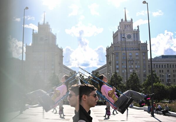 Девушка катается на качелях на Триумфальной площади в Москве