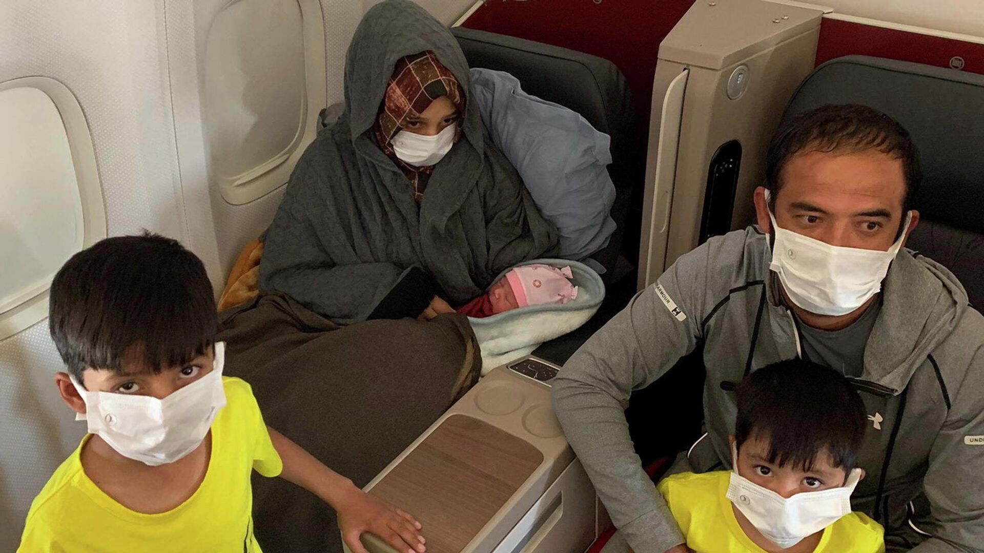 Афганская скемья со своей новорожденной дочерью на борту эвакуационного рейса, выполняемого Turkish Airlines из Дубая в Бирмингем - РИА Новости, 1920, 28.08.2021