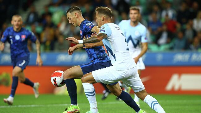 Soccer Football - World Cup - UEFA Qualifiers - Group H - Slovenia v Slovakia - Stozice Stadium, Ljubljana, Slovenia - September 1, 2021 Slovakia's Robert Bozenik in action with Slovenia's Jure Balkovec REUTERS/Borut Zivulovic