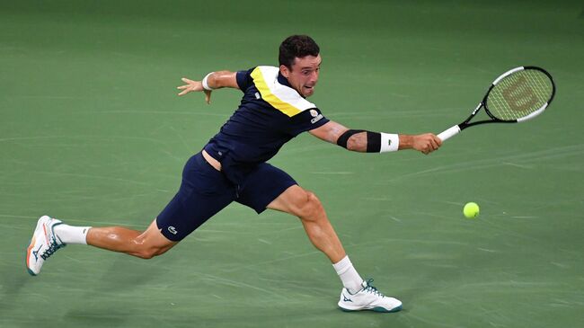 Spain's Roberto Bautista Agut hits a return to Australia's Nick Kyrgios during their 2021 US Open Tennis tournament men's singles first round match at the USTA Billie Jean King National Tennis Center in New York, on August 30, 2021. (Photo by Ed JONES / AFP)