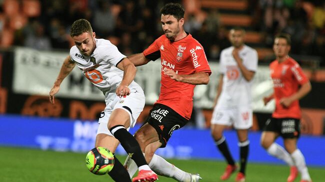 Lorient's French midfielder Thomas Monconduit (R) fights for the ball with Lille's defender Gabriel Johan Gudmundsson during the French L1 football match between FC Lorient and LOSC Lille, at the Moustoir stadium in Lorient, north-western France on September 10, 2021. (Photo by Fred TANNEAU / AFP)