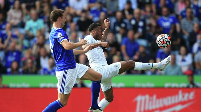 Leicester City's Northern Irish defender Jonny Evans (L) chases Manchester City's English midfielder Raheem Sterling during the English Premier League football match between Leicester City and Manchester City at King Power Stadium in Leicester, central England on September 11, 2021. (Photo by Lindsey Parnaby / AFP) / RESTRICTED TO EDITORIAL USE. No use with unauthorized audio, video, data, fixture lists, club/league logos or 'live' services. Online in-match use limited to 120 images. An additional 40 images may be used in extra time. No video emulation. Social media in-match use limited to 120 images. An additional 40 images may be used in extra time. No use in betting publications, games or single club/league/player publications. / 