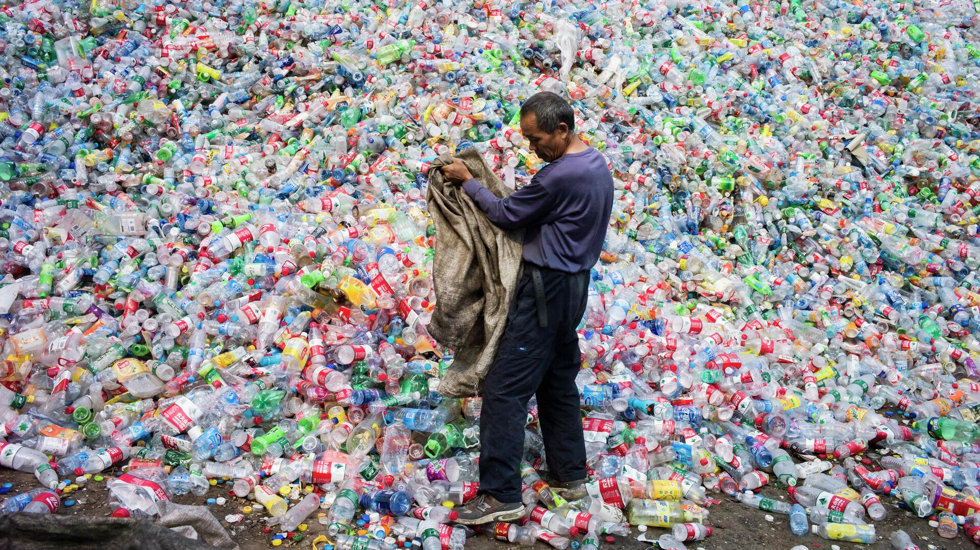 Китайский рабочий, сортирующий пластиковые бутылки для переработки, на окраине Пекина - РИА Новости, 1920, 16.09.2021