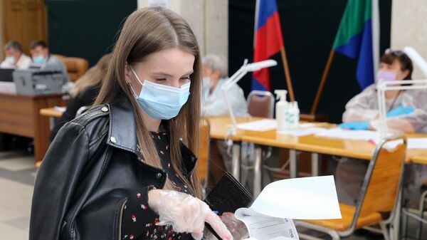 Девушка голосует на избирательном участке в Хабаровске
