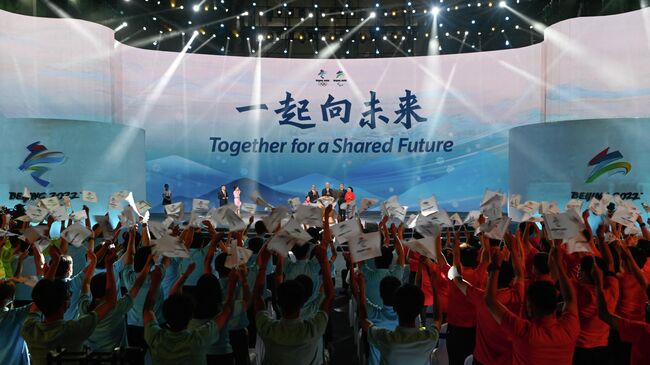 'Together for a Shared Future' is displayed during the launch ceremony of the slogan for the Beijing 2022 Olympic and Paralympic Games in Beijing on September 17, 2021. (Photo by WANG Zhao / AFP)