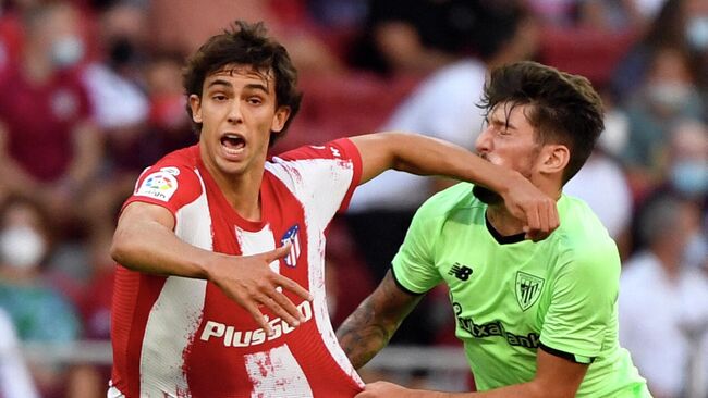 Atletico Madrid's Portuguese midfielder Joao Felix (L) fouls Athletic Bilbao's Spanish midfielder Unai Vencedor during the Spanish League football match between Club Atletico de Madrid and Athletic Club Bilbao at the Wanda Metropolitano stadium in Madrid on September 18, 2021. (Photo by PIERRE-PHILIPPE MARCOU / AFP)