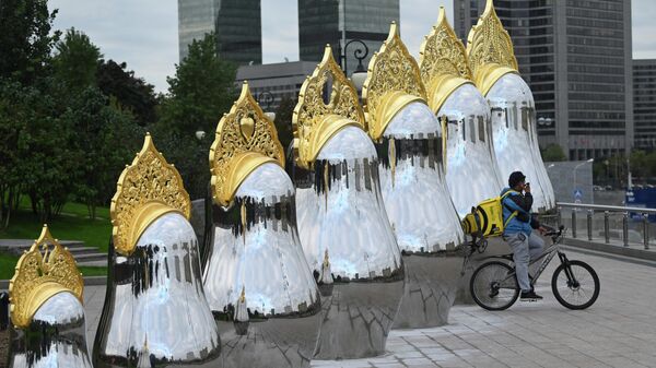 Зеркальные матрешки в золотых кокошниках напротив гостиницы Украина в Москве