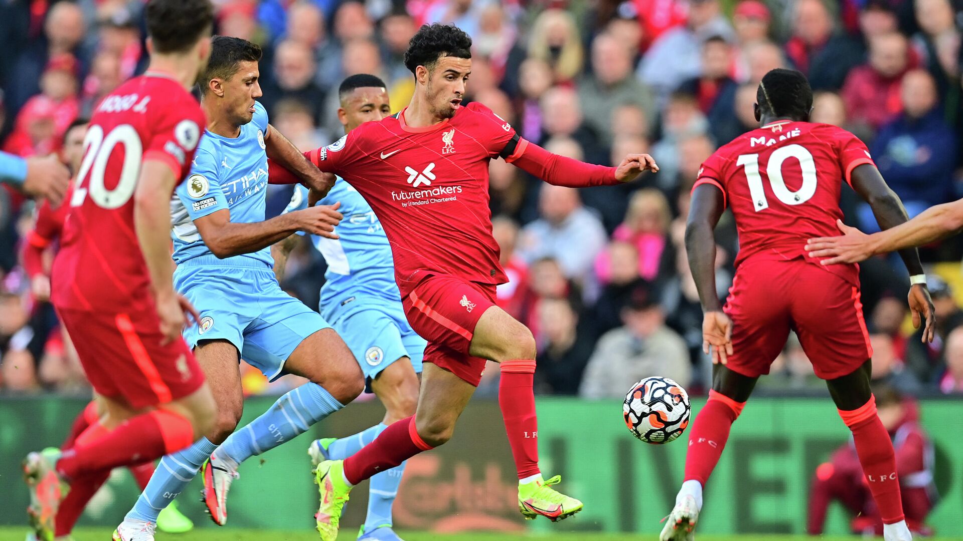 Manchester City's Spanish midfielder Rodrigo challenges Liverpool's English midfielder Curtis Jones (C) during the English Premier League football match between Liverpool and Manchester City at Anfield in Liverpool, northwest England, on October 3, 2021. (Photo by Paul ELLIS / AFP) / RESTRICTED TO EDITORIAL USE. No use with unauthorized audio, video, data, fixture lists, club/league logos or 'live' services. Online in-match use limited to 120 images. An additional 40 images may be used in extra time. No video emulation. Social media in-match use limited to 120 images. An additional 40 images may be used in extra time. No use in betting publications, games or single club/league/player publications. /  - РИА Новости, 1920, 03.10.2021