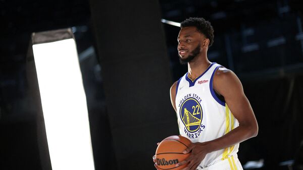 (FILES) In this file photo Andrew Wiggins #22 of the Golden State Warriors poses for a portrait during the Golden State Warriors Media Day at Chase Center on September 27, 2021 in San Francisco, California. - The NBA said on September 29, 2021 players who do not comply with local Covid-19 vaccination mandates will be docked pay for games they are forced to miss because of their status. The policy means players with teams based in San Francisco and New York -- where local regulations require full vaccination for indoor events -- must get vaccinated or else risk seeing their pay effectively cut in half. (Photo by EZRA SHAW / GETTY IMAGES NORTH AMERICA / AFP)