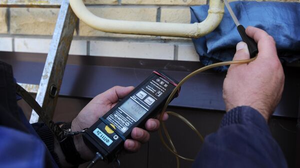 Сотрудник  АО Газпром газораспределение Тамбов проверяет на утечку фасадный газопровод в многоквартирном жилом доме Тамбове
