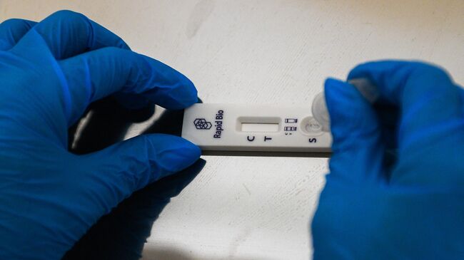 Медицинский работник проводит экспресс-тестирование на COVID-19 