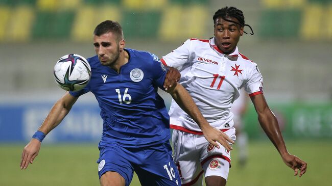 Soccer Football - World Cup - UEFA Qualifiers - Group H - Cyprus v Malta - AEK Arena - George Karapatakis, Larnaca, Cyprus - October 11, 2021 Cyprus' Costas Soteriou in action with Malta's Paul Mbong REUTERS/Yiannis Kourtoglou