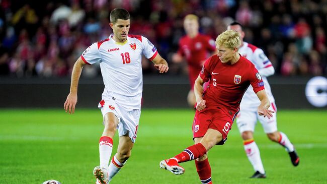 Soccer Football - World Cup - UEFA Qualifiers - Group G - Norway v Montenegro - Ullevaal Stadion, Oslo, Norway - October 11, 2021 Montenegro's Nebojsa Kosovic in action with Norway's Birger Meling Hakon Mosvold Larsen/NTB via REUTERS    ATTENTION EDITORS - THIS IMAGE WAS PROVIDED BY A THIRD PARTY. NORWAY OUT. NO COMMERCIAL OR EDITORIAL SALES IN NORWAY.