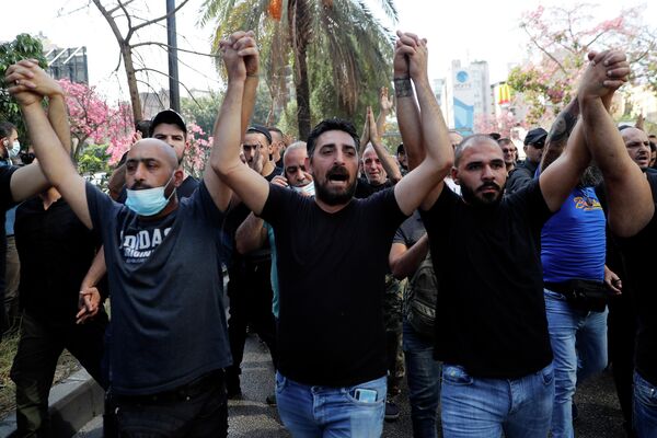 Сторонники шиитских группировок Хезболла и Амаль выкрикивают лозунги против судьи Тарека Битара