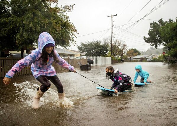 Дети играют на затопленной улице в Милл-Валли, Калифорния