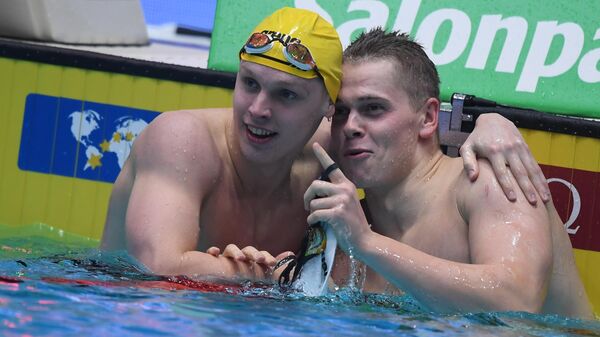 Мэтью Сэйтс (ЮАР) и Данас Рапсис (Литва) после финиша в финальном заплыве на 200 метров вольным стилем среди мужчин на IV этапе Кубка мира по плаванию в Казани.