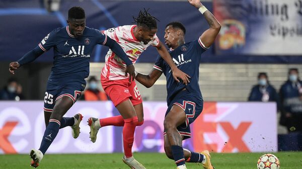 (L-R) Paris Saint-Germain's Portuguese defender Nuno Mendes, Leipzig's French midfielder Christopher Nkunku and Paris Saint-Germain's French defender Presnel Kimpembe vie for the ball during the UEFA Champions League, Group A, football match RB Leipzig v Paris Saint-Germain in Leipzig, eastern Germany on November 3, 2021. (Photo by FRANCK FIFE / AFP)