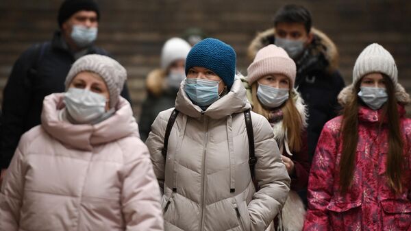 Пассажиры в защитных масках на станции метро Красный проспект в Новосибирске