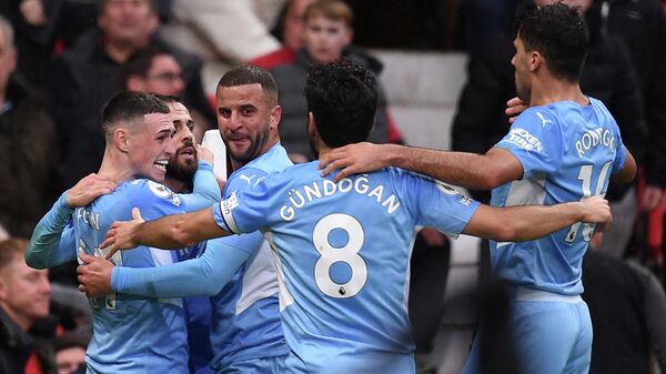 Manchester City's Portuguese midfielder Bernardo Silva (2L) celebrates scoring his team's second goal with teammates during the English Premier League football match between Manchester United and Manchester City at Old Trafford in Manchester, north west England, on November 6, 2021. (Photo by Oli SCARFF / AFP) / RESTRICTED TO EDITORIAL USE. No use with unauthorized audio, video, data, fixture lists, club/league logos or 'live' services. Online in-match use limited to 120 images. An additional 40 images may be used in extra time. No video emulation. Social media in-match use limited to 120 images. An additional 40 images may be used in extra time. No use in betting publications, games or single club/league/player publications. / 