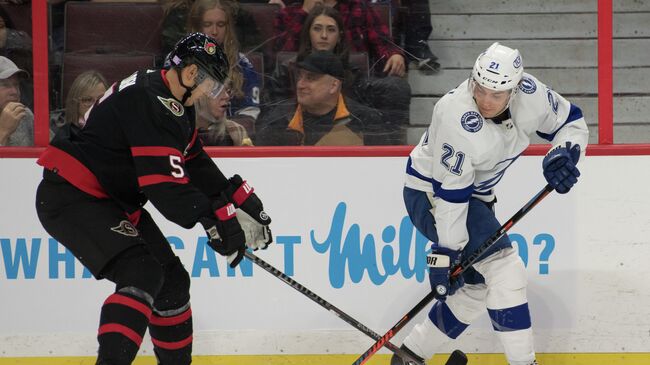 Nov 6, 2021; Ottawa, Ontario, CAN; Ottawa Senators defenseman Nick Holden (5) and Tampa Bay Lightning defenseman Zach Bogosian (21) battle in the first period at the Canadian Tire Centre. Mandatory Credit: Marc DesRosiers-USA TODAY Sports