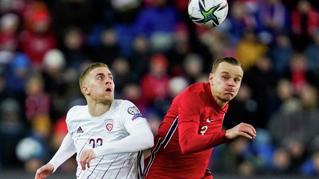 Soccer Football - World Cup - UEFA Qualifiers - Group G - Norway v Latvia - Ullevaal Stadion, Oslo, Norway - November 13, 2021 Latvia's Vladislavs Gutkovskis in action with Norway's Marius Lode  Stian Lysberg Solum/NTB via REUTERS    ATTENTION EDITORS - THIS IMAGE WAS PROVIDED BY A THIRD PARTY. NORWAY OUT. NO COMMERCIAL OR EDITORIAL SALES IN NORWAY.