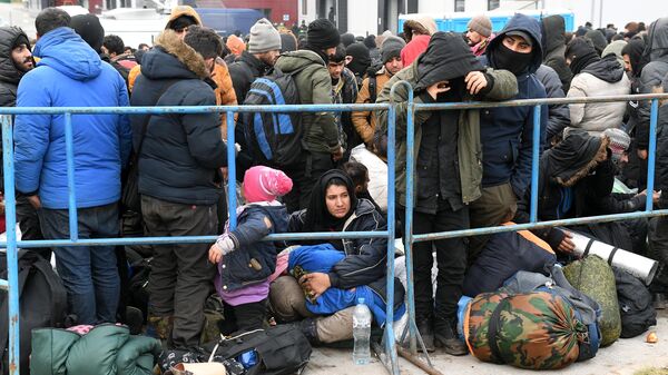 Беженцы с Ближнего Востока ожидают размещения в центре временного содержания мигрантов, оборудованном в логистическом центре в пункте пропуска Брузги, на белорусско-польской границе