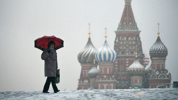Женщина во время снегопада на Красной площади в Москве